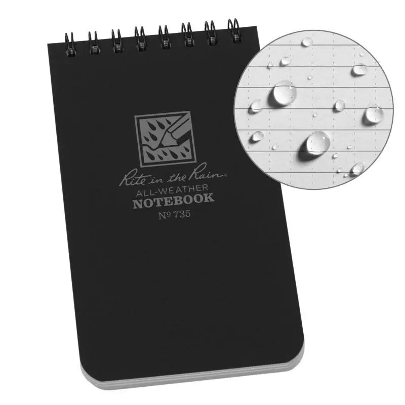Black all-weather notebook with water droplets on a white background