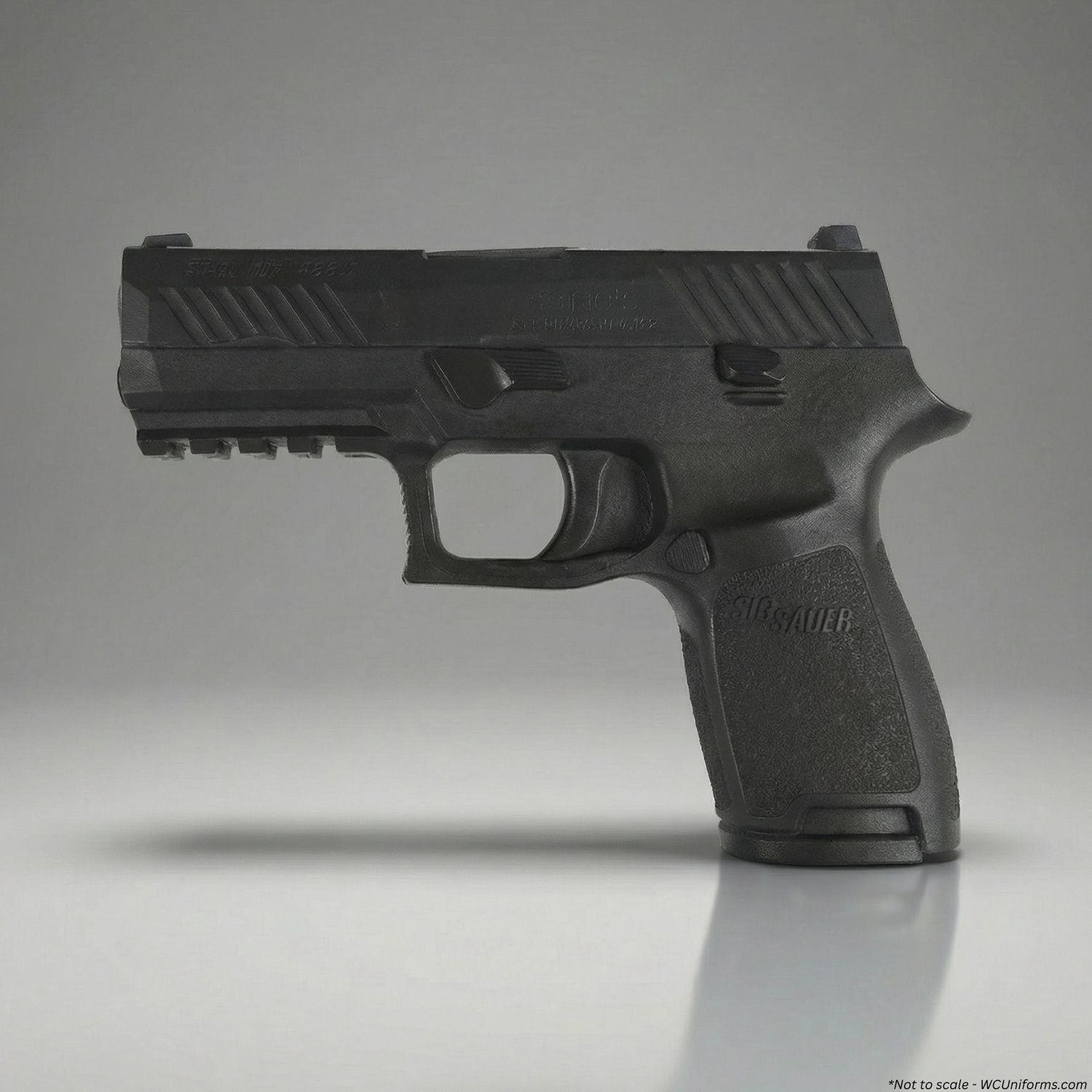 Black training handgun on a gray background