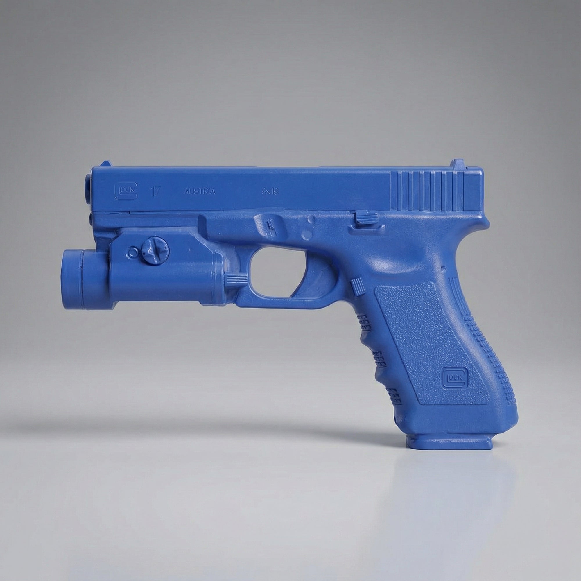 Blue plastic gun model on a gray background