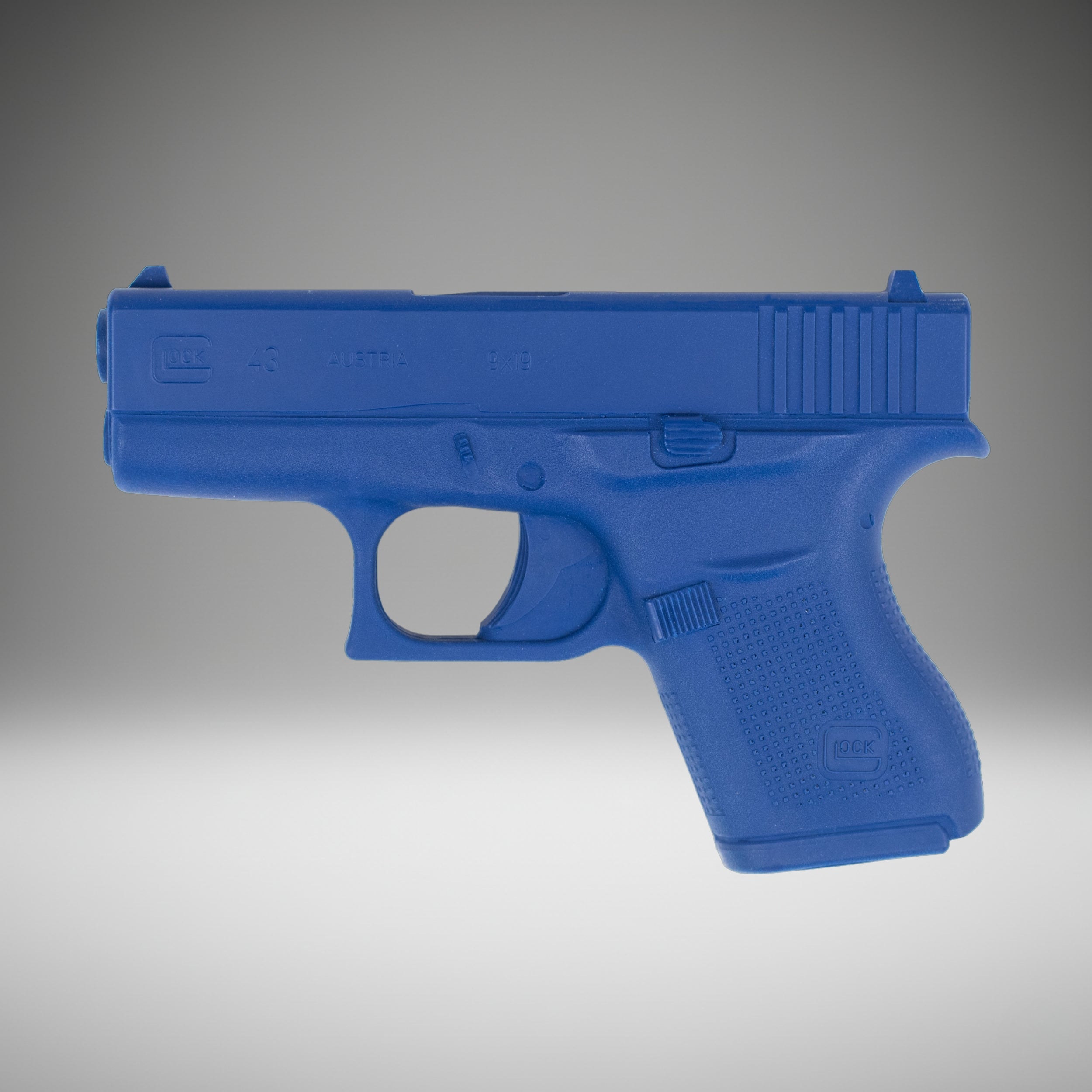 Blue plastic Blue Training Guns By Rings Glock 43 FSG43 on a gray background