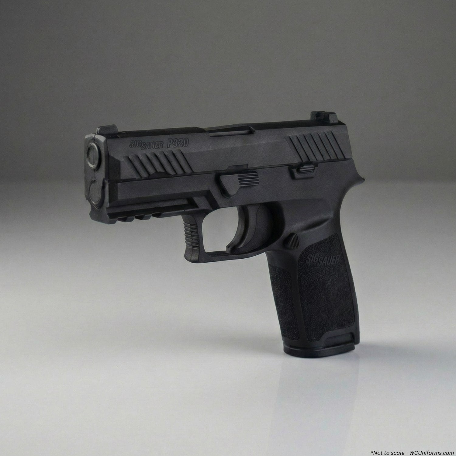 Black training gun handgun on a gray background
