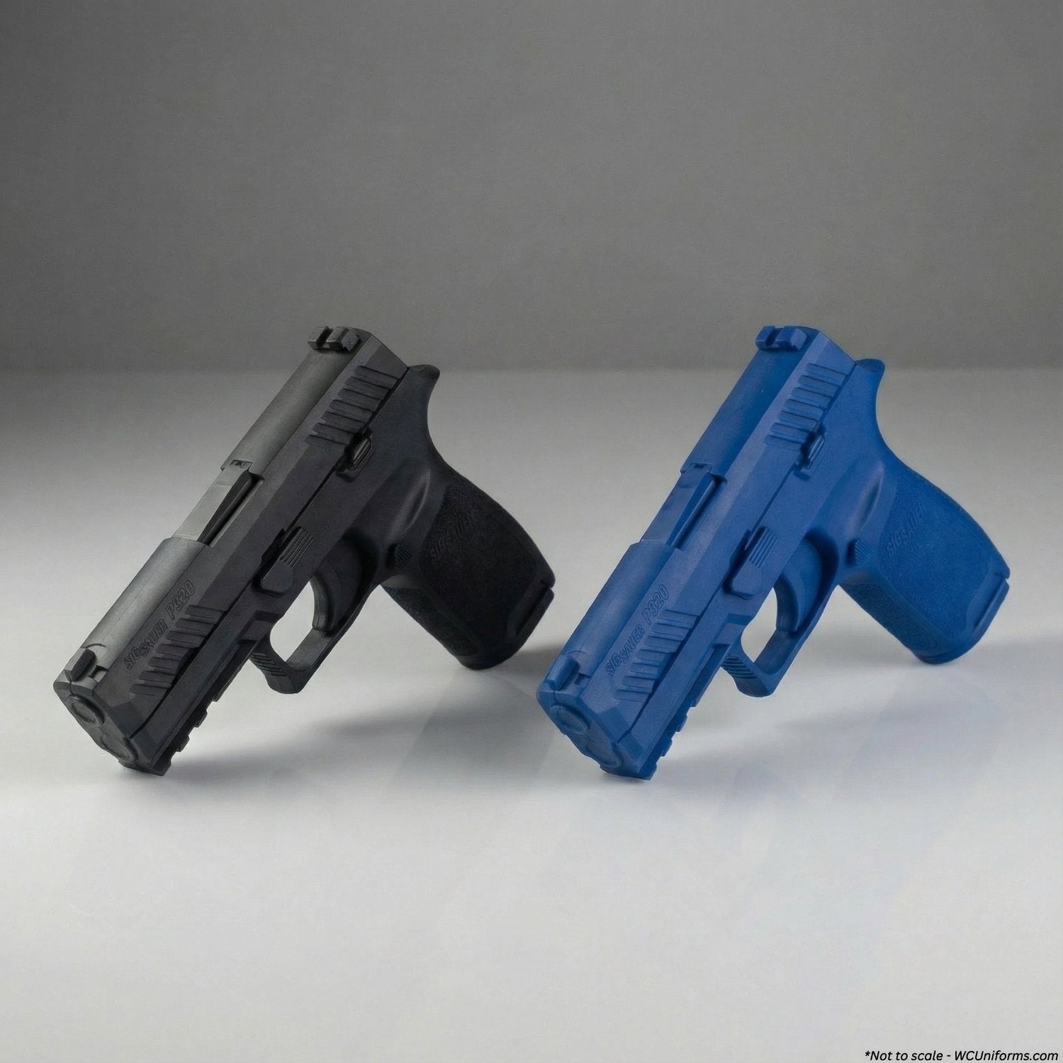 Black and blue plastic guns on a gray background