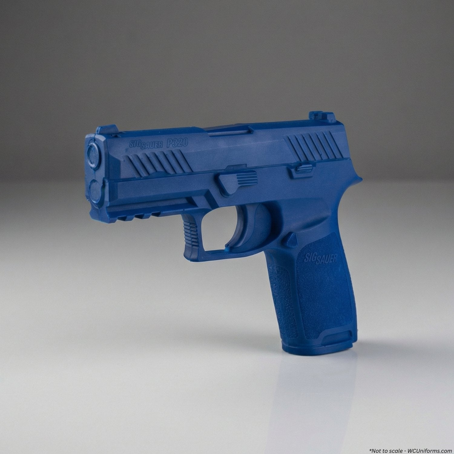 Blue plastic training gun model on a gray background