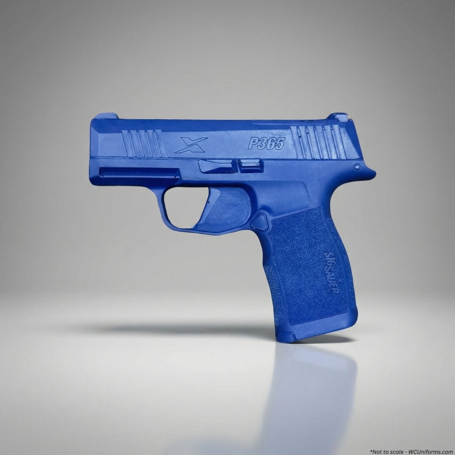 Blue plastic gun model on a gray background