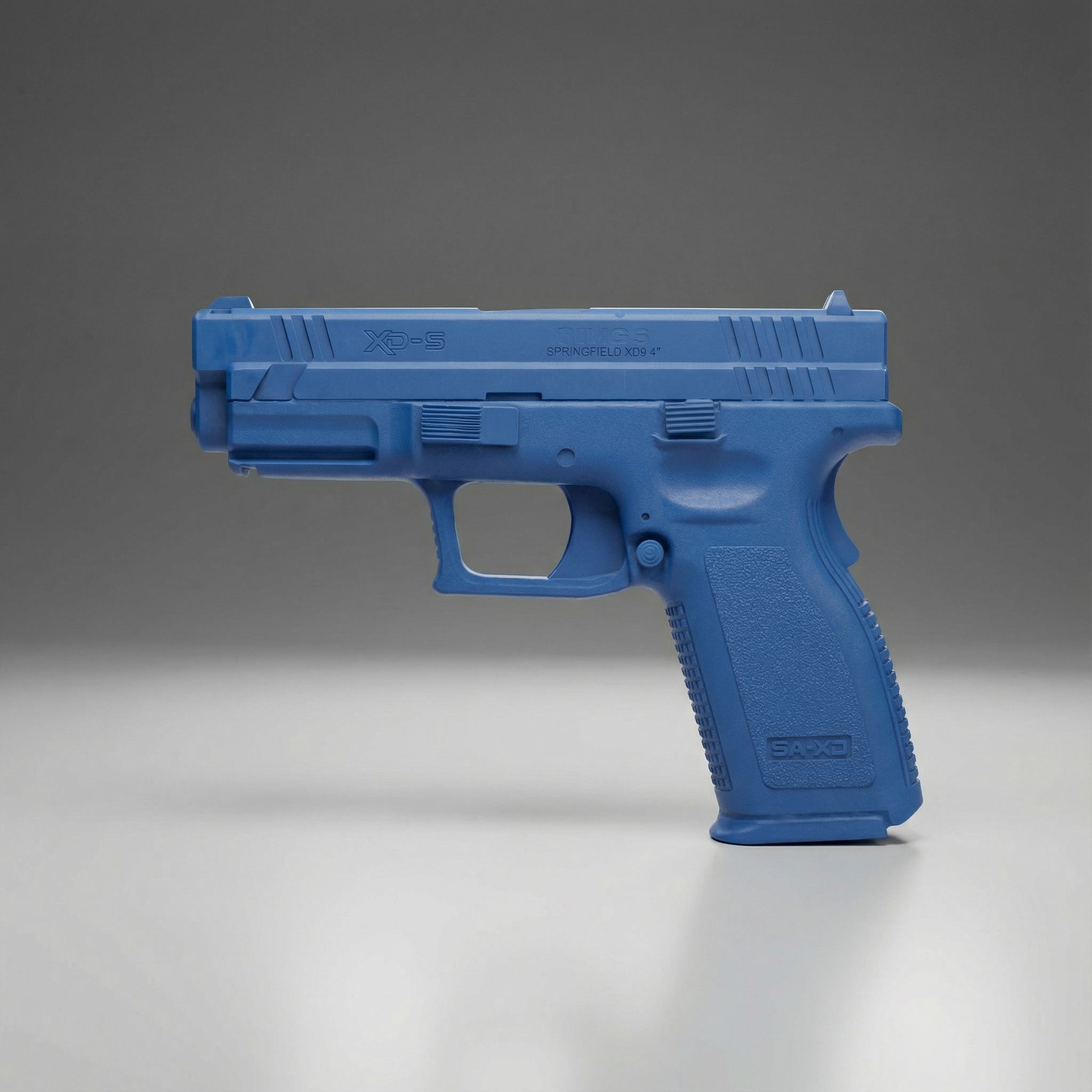 Blue gun-shaped Blue Training Guns By Rings Springfield XD9 | FSXD9101 on a gray background