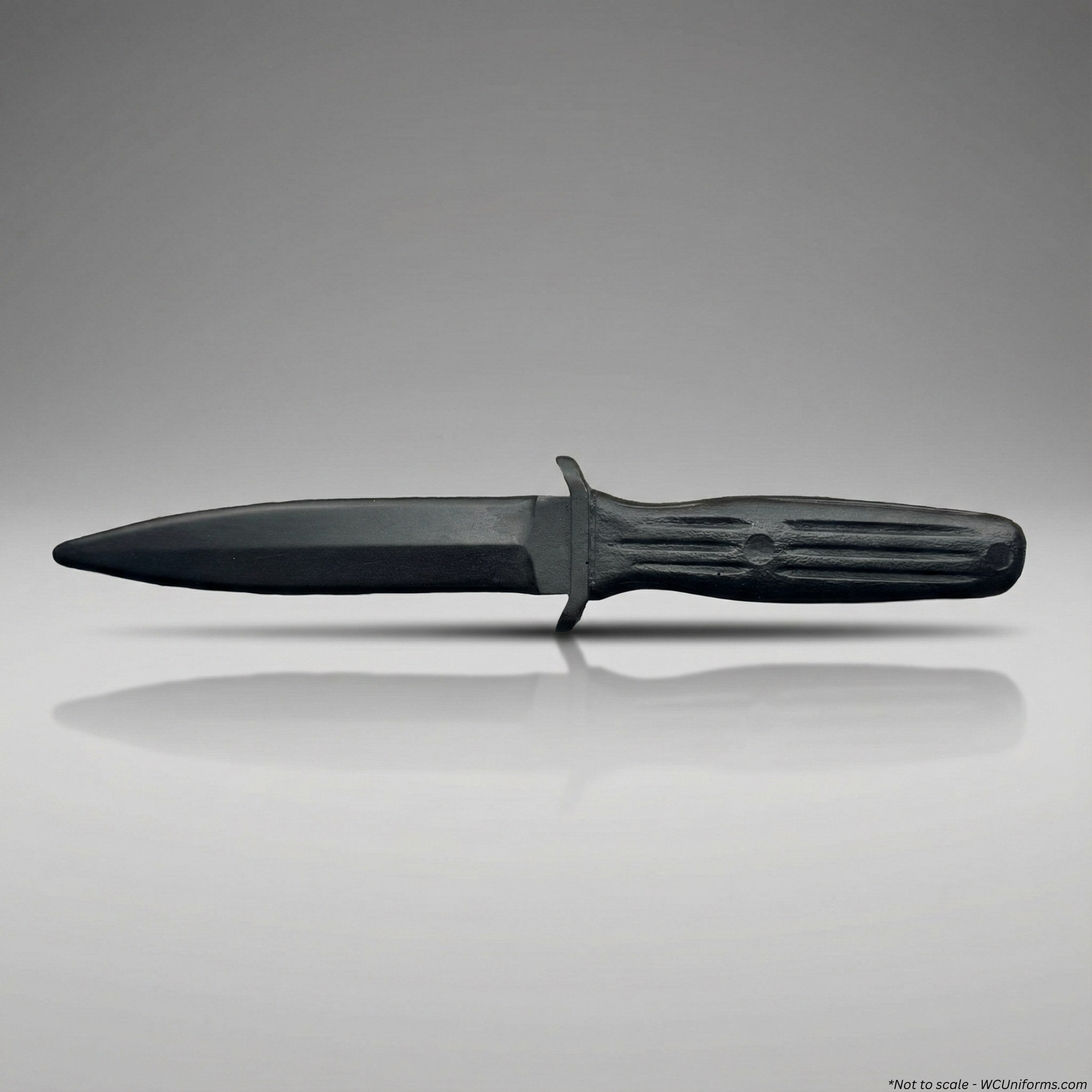 Black training knife with a textured handle on a gray background