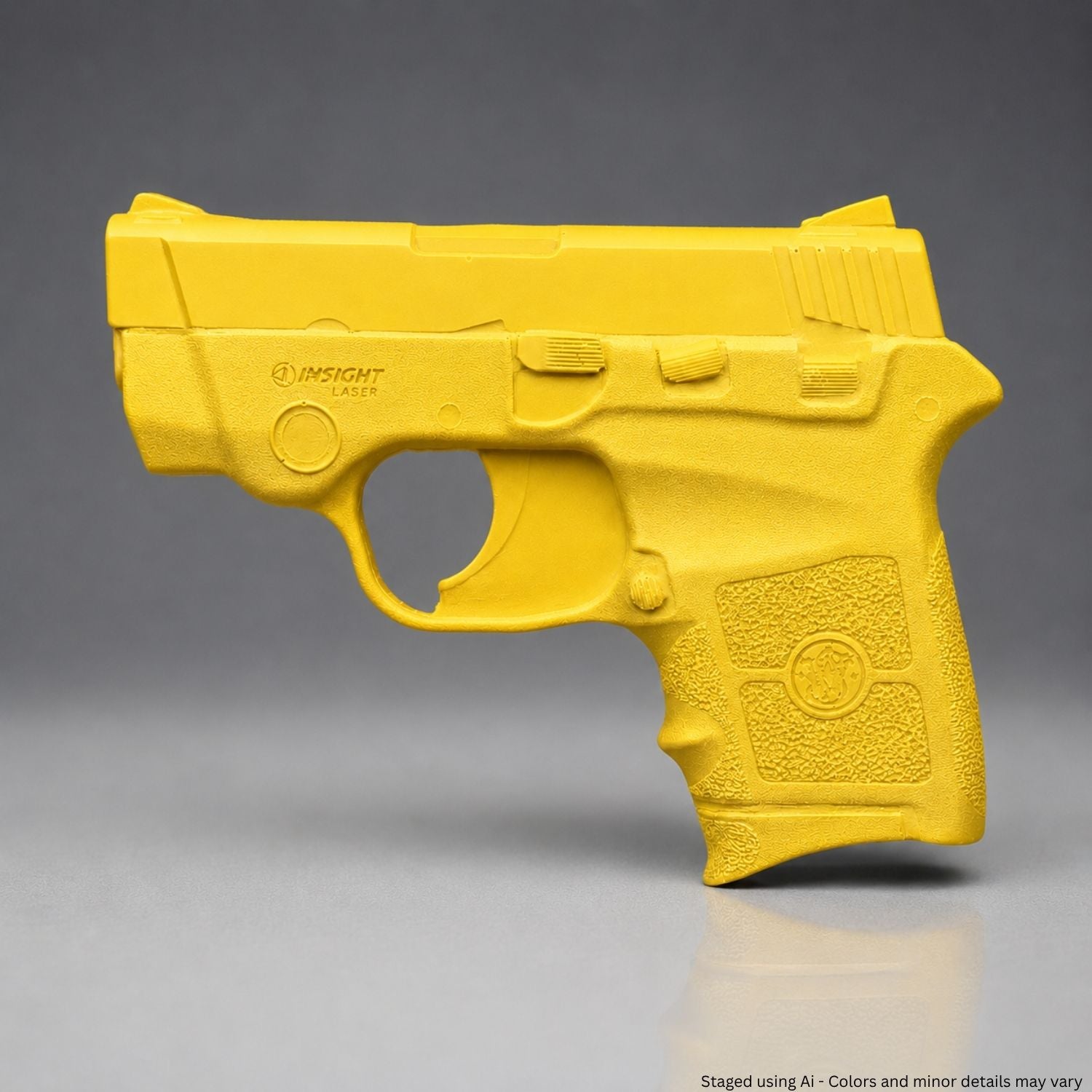 A Yellow Smith & Wesson Bodyguard .380 Training Gun on a gray background