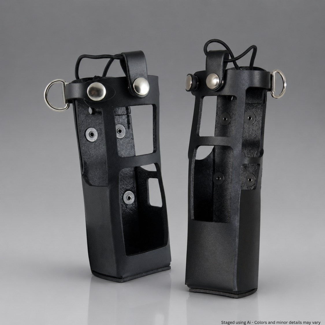 Two black leather radio holsters with metal loops on a gray background