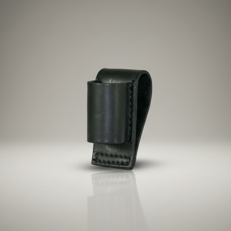 Black leather loop style flashlight holder on a reflective surface with a gradient background