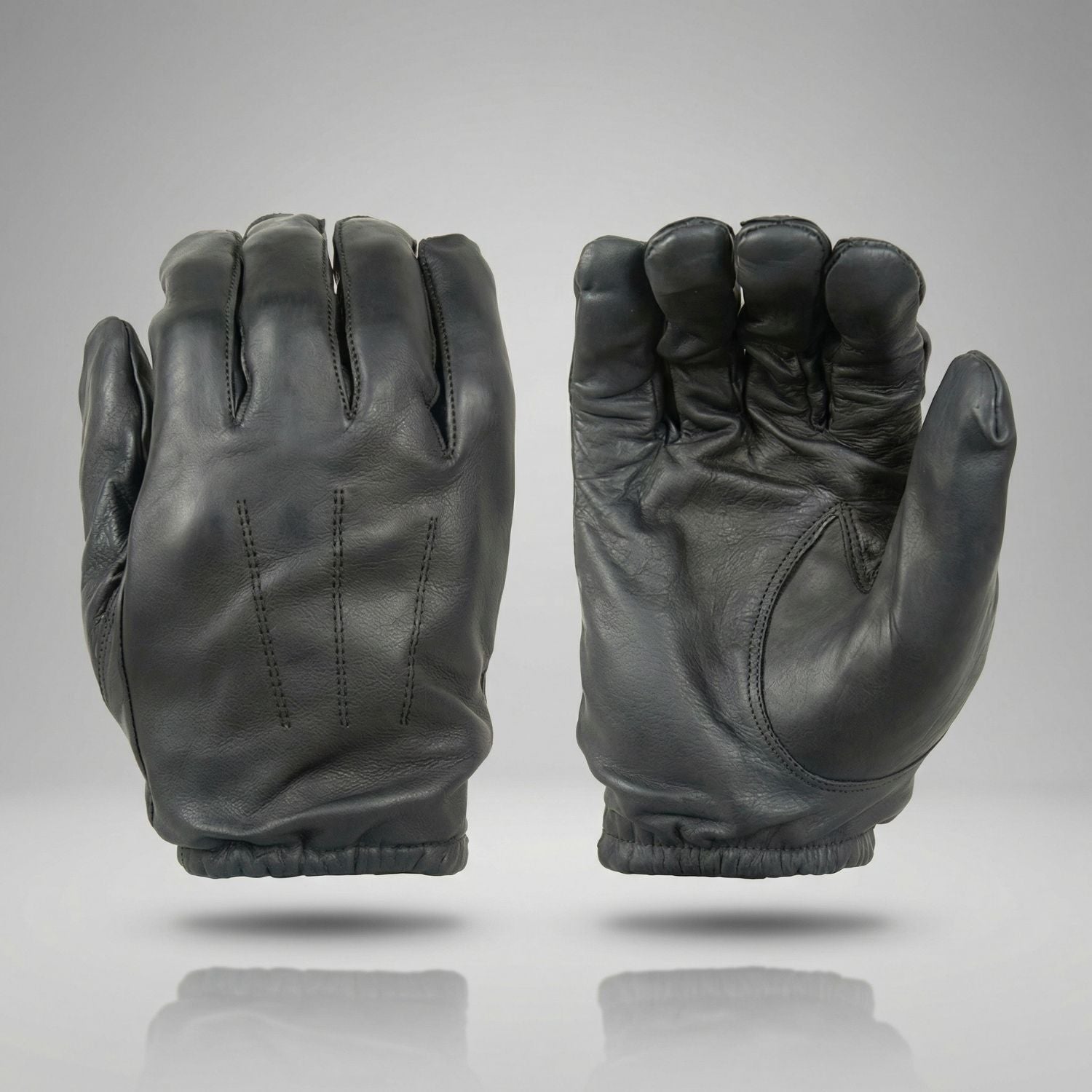 Pair of black leather gloves on a gray background