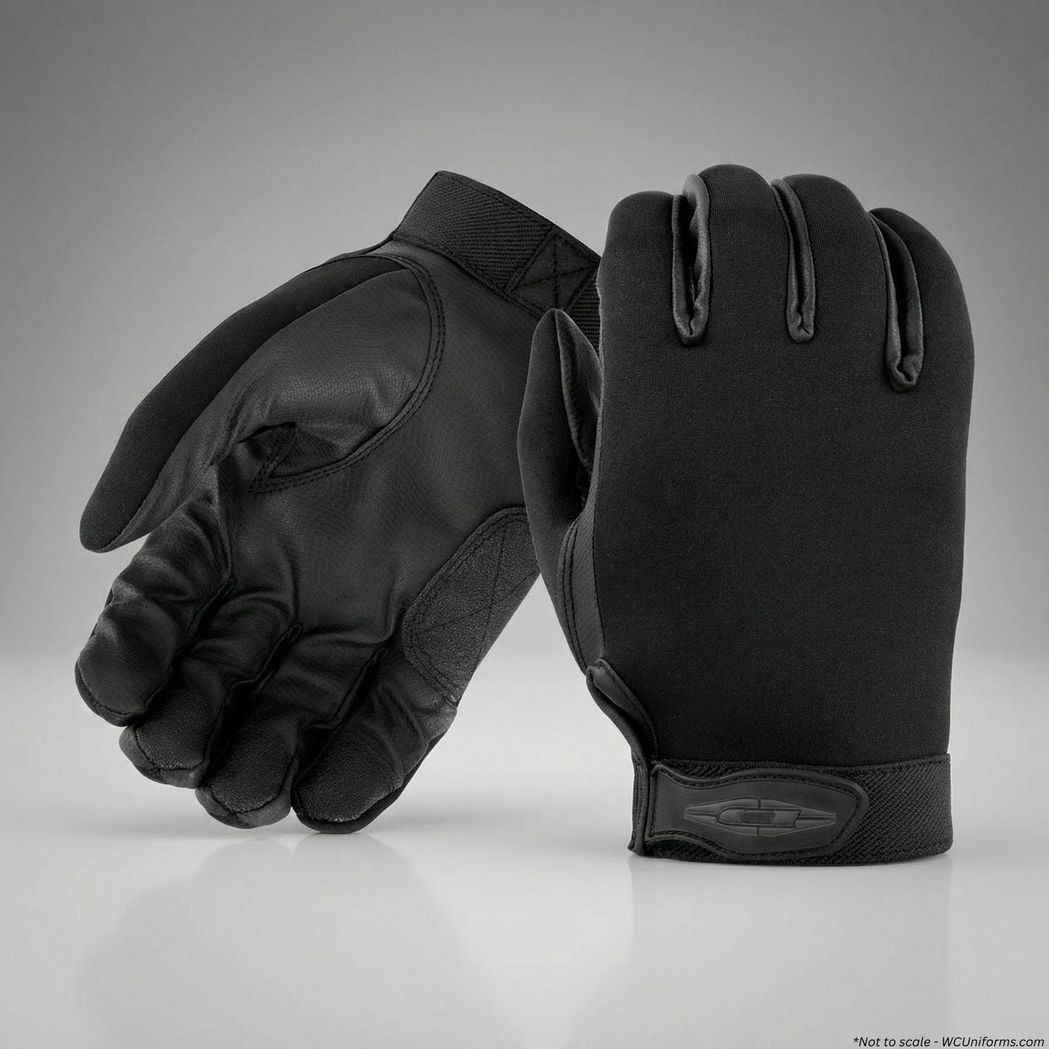 Pair of black tactical gloves on a gray background