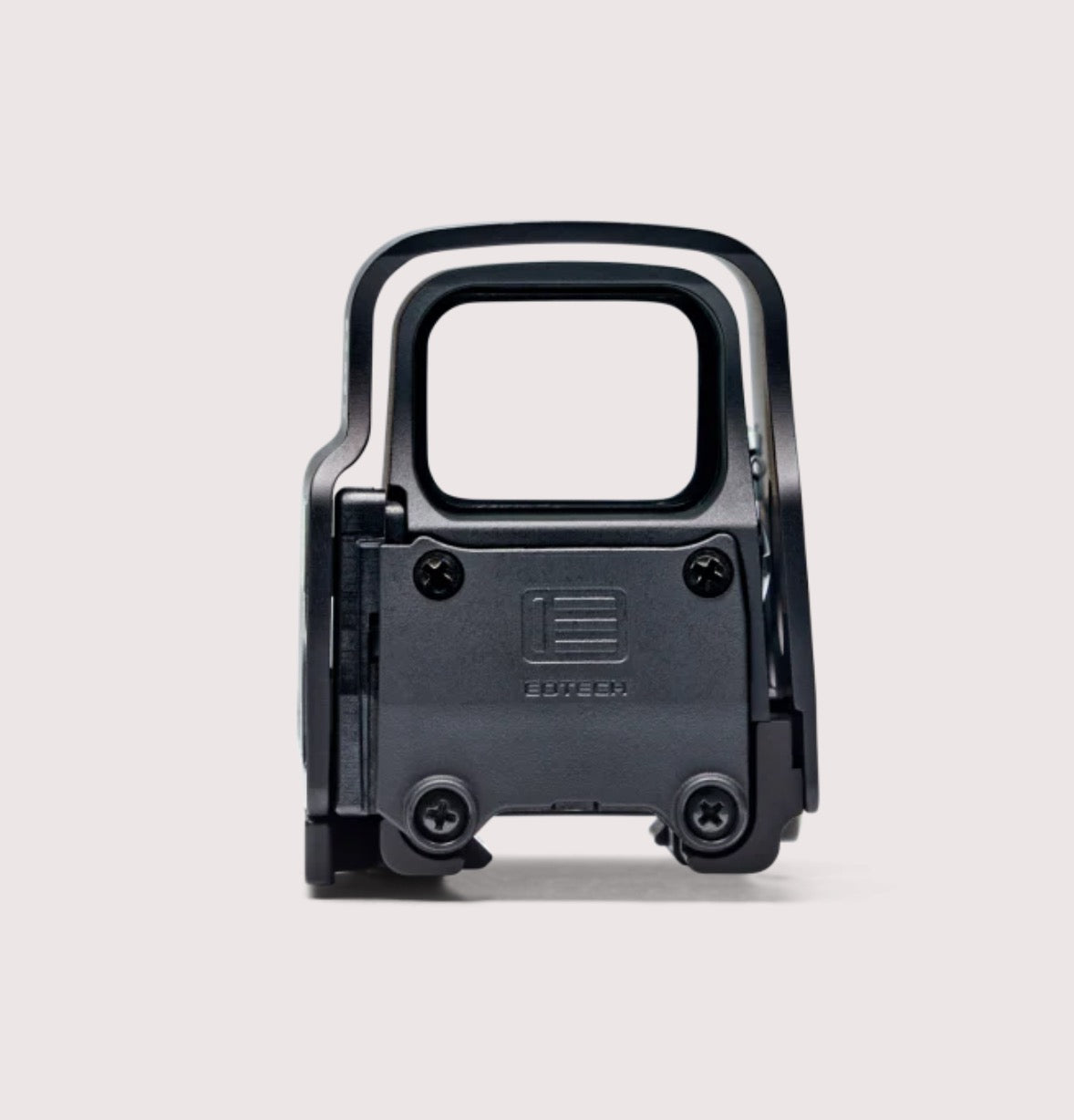 Black tactical gun sight on a light gray background