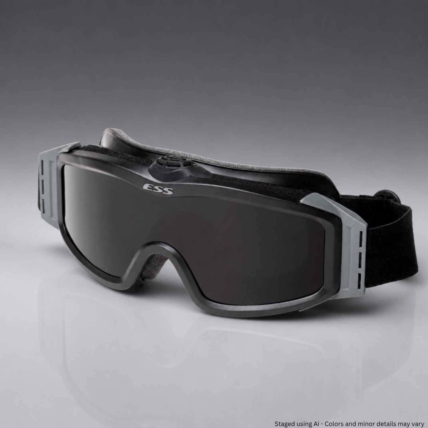 Black goggles with a gray strap on a gray background