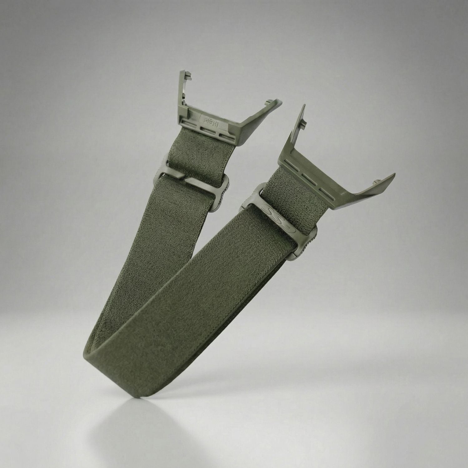Green googgle strap with a buckle on a gray background