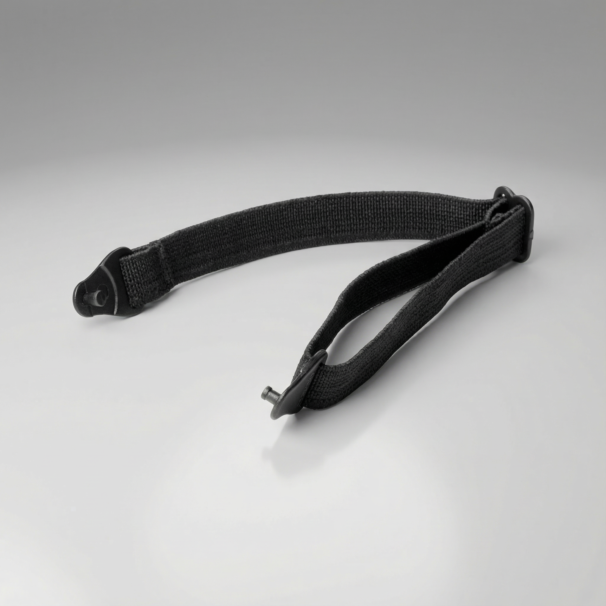 Black eyewear strap with a buckle on a gray background
