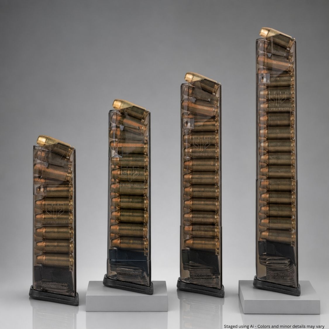 Four clear ammunition magazines on a gray background