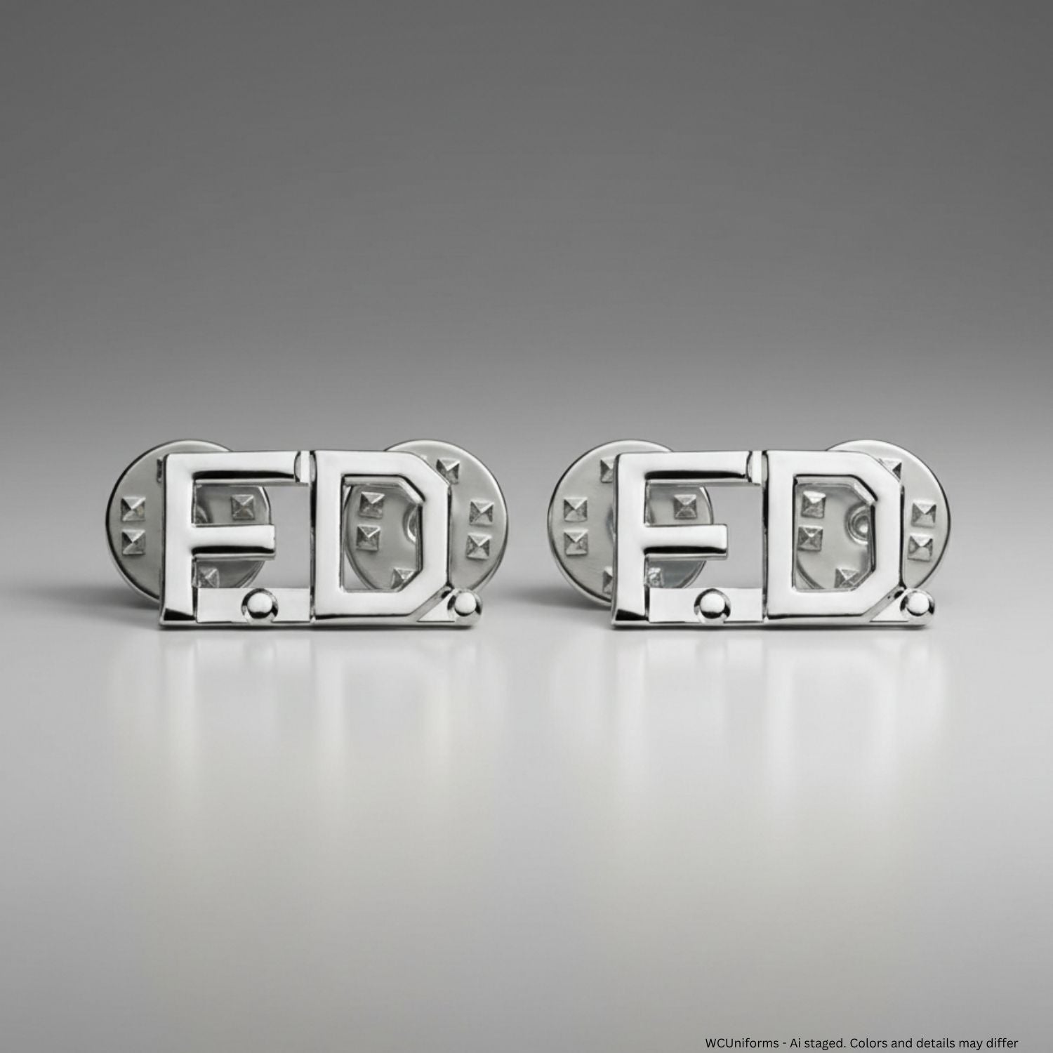 Silver collar pins with 'F.D.' design on a gray background