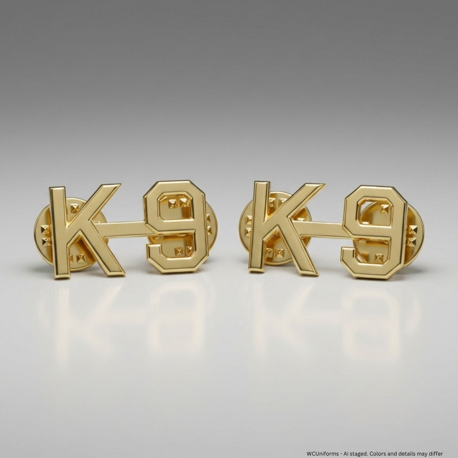 Two gold 'K-9' pins on a gray background