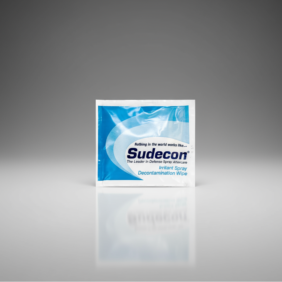 Sudecon packaging on a reflective surface with a gray gradient background