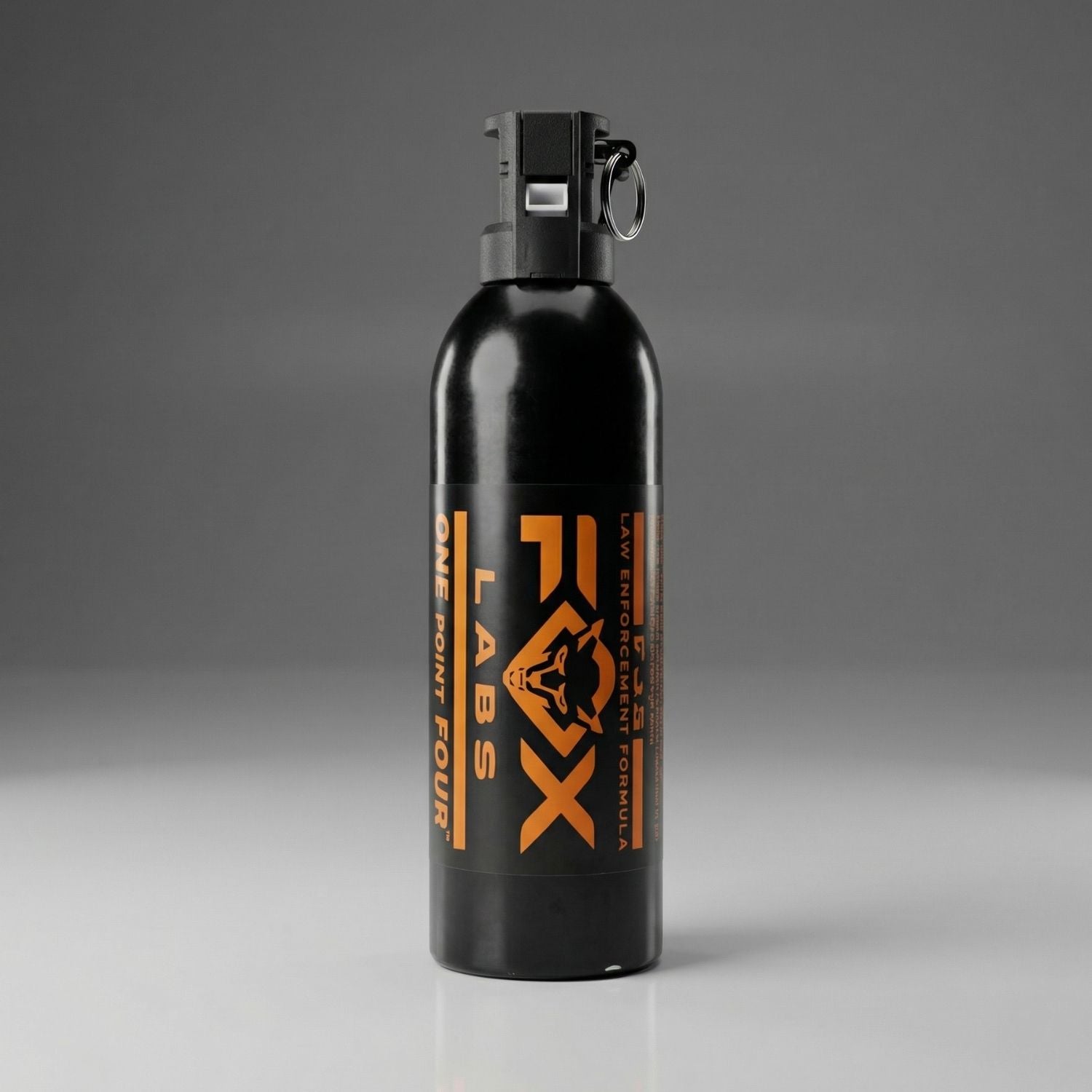 Black pepper spray canister with orange text on a gray background