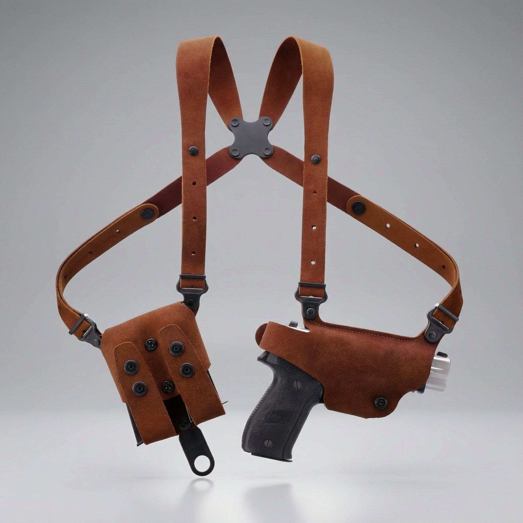Brown leather gun holster with shoulder straps on a gray background