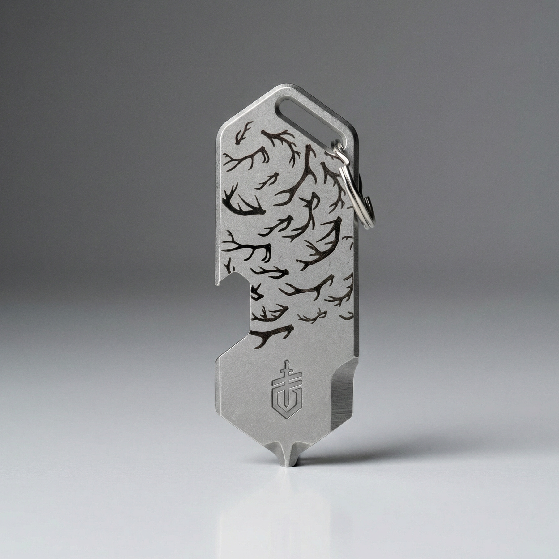 Metal multitool with engraved design on a gray background