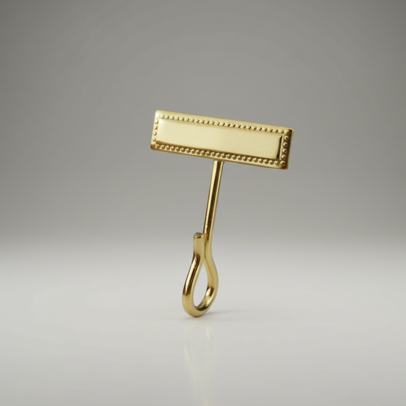 Gold-colored Hero's Pride Uniform Whistle Hook 4015 on a gray background