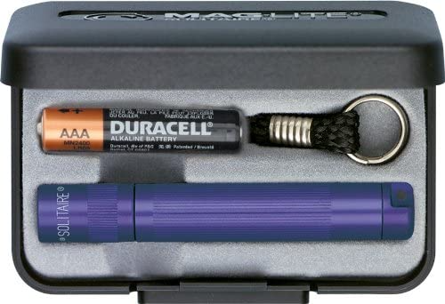 Maglite Solitaire flashlight set with Duracell AAA battery, keychain, and storage case for portable illumination.