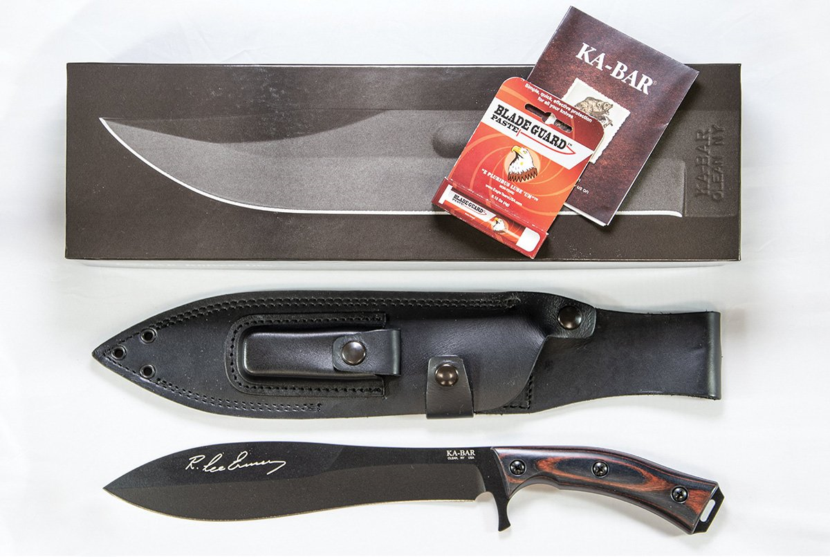 Ka-Bar Gunny Knife with black leather sheath, R. Lee Ermey signature, and blade guard packaging displayed together.
