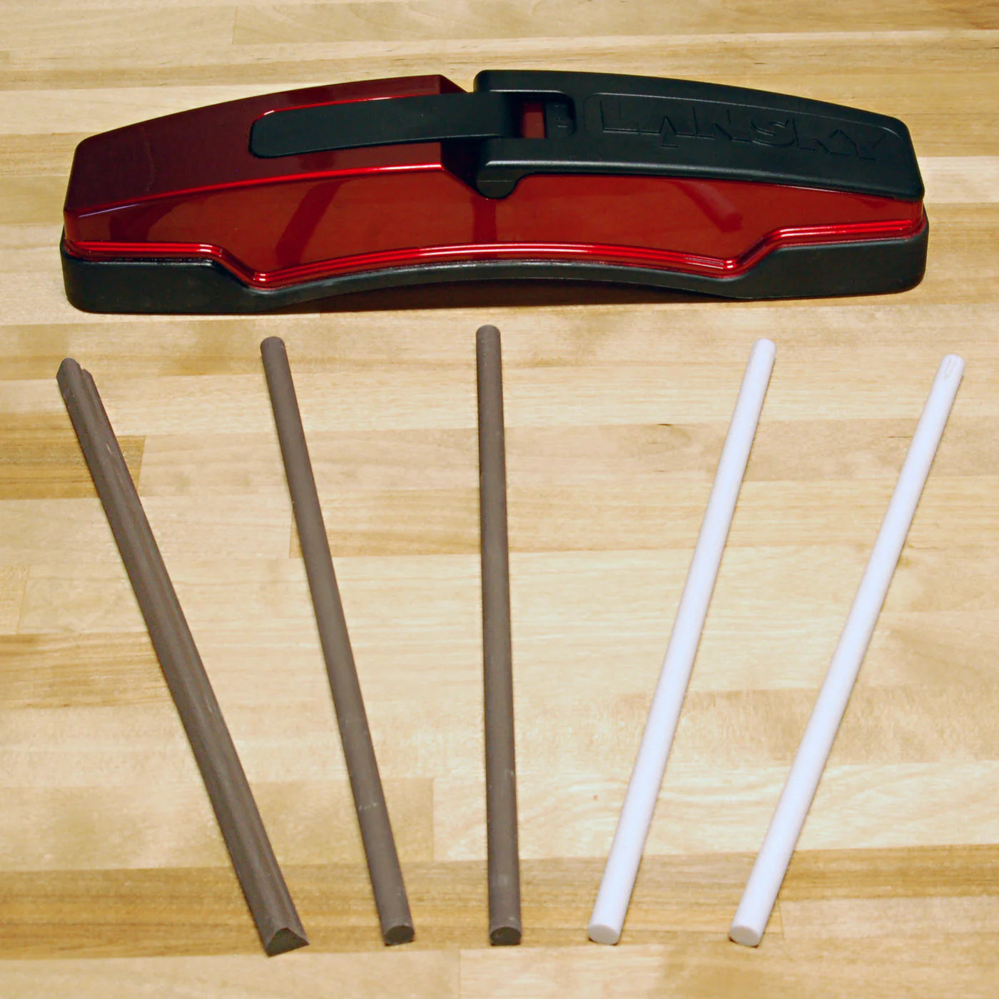 Lansky Master's Edge MEDGE1 sharpener with all included ceramic rods displayed, showing two grey medium round rods, two white fine round rods, and the medium triangular serration rod