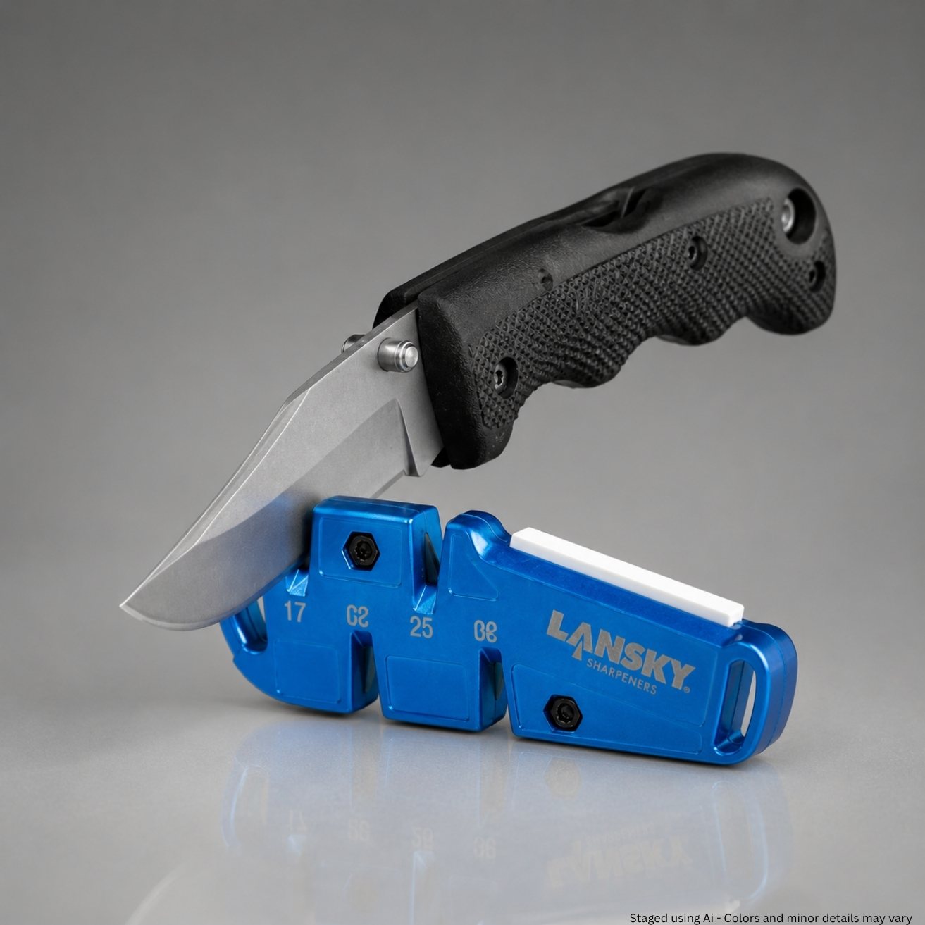 Lansky QuadSharp QSHARP pocket sharpener displayed beside a folding knife, showing the compact two-block pull-through carbide design and white ceramic benchstone