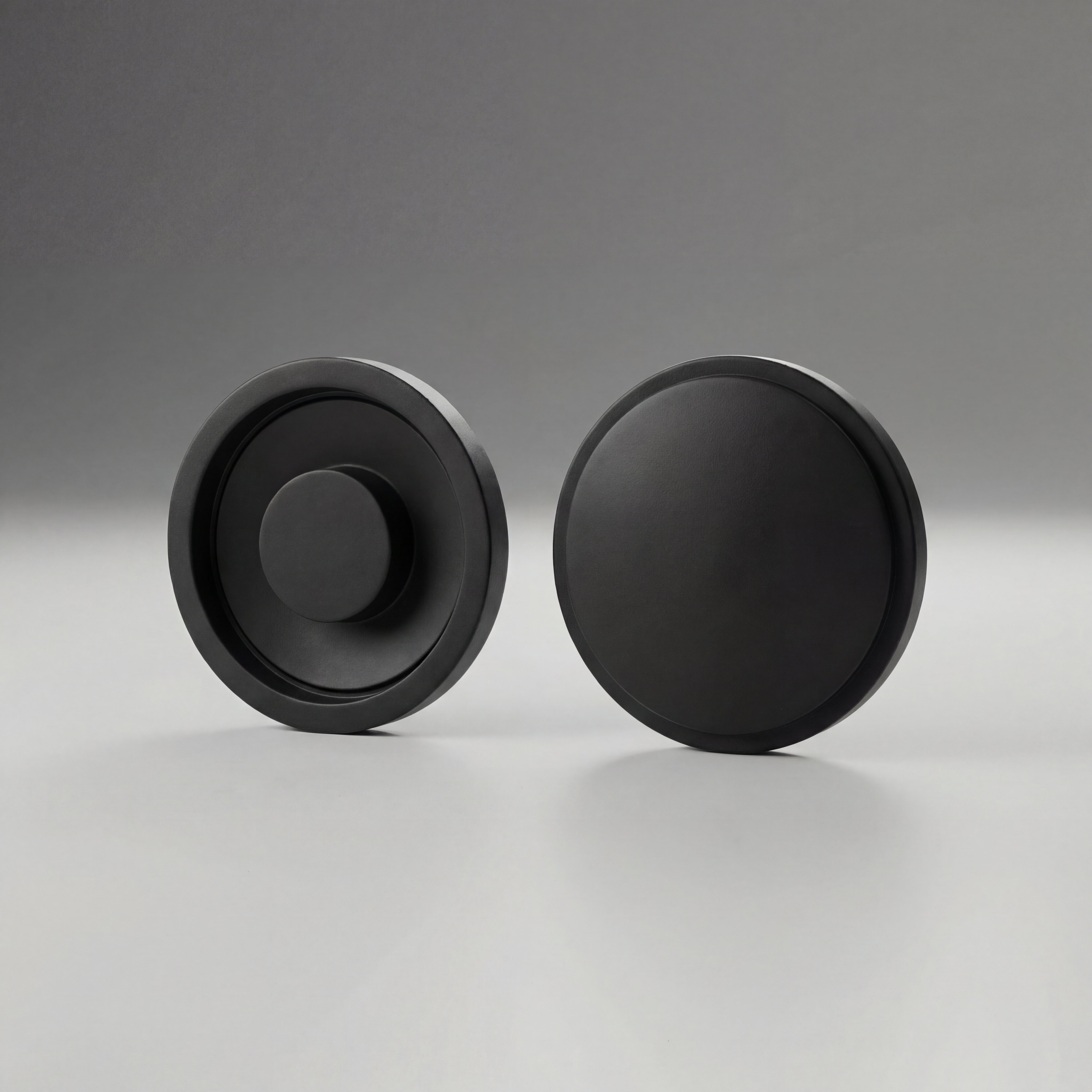 Two black Maglite Replacement Switch Seal Magcharger 108-000-643 on a gray background