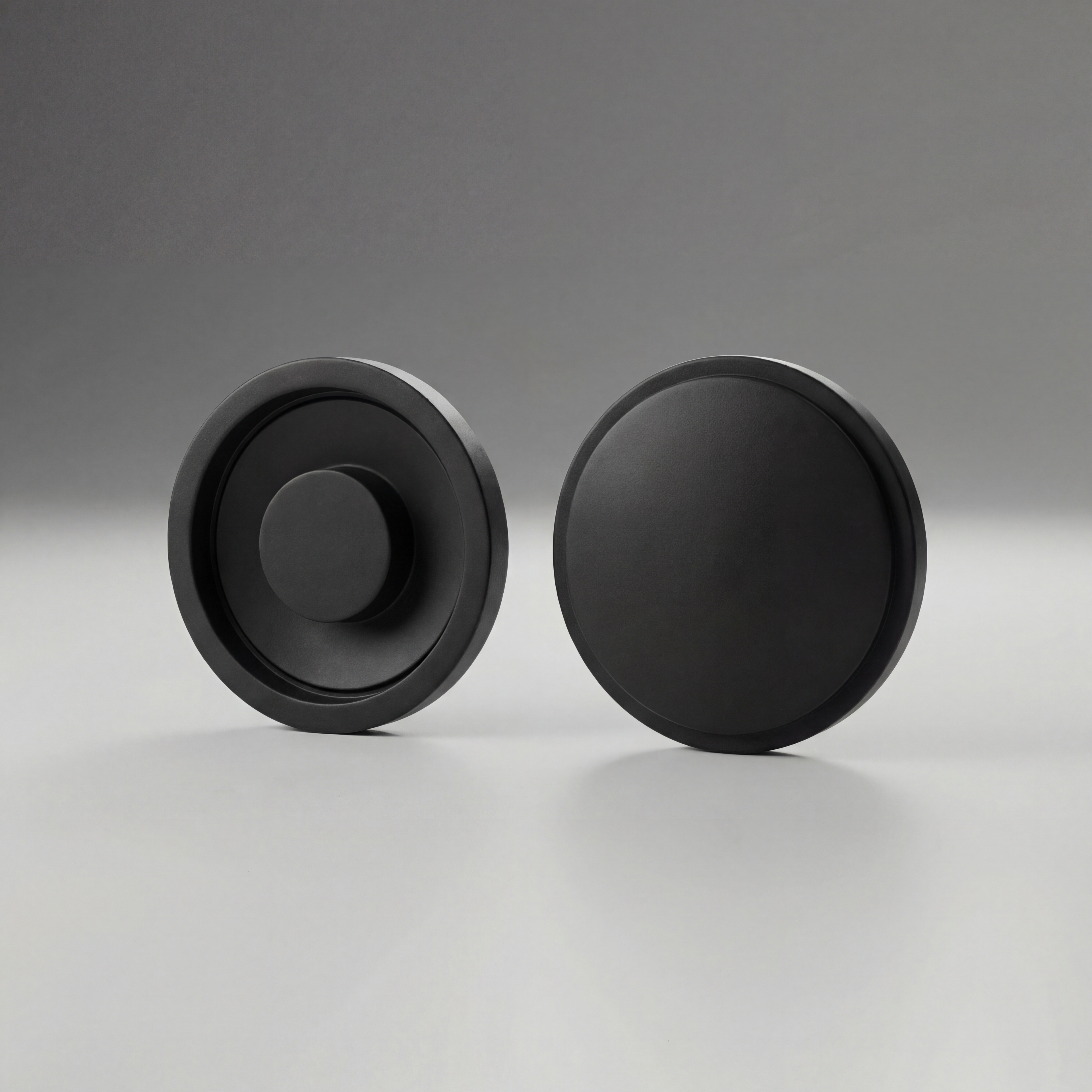 Two black Maglite Replacement Switch Seal Magcharger 108-000-643 on a gray background