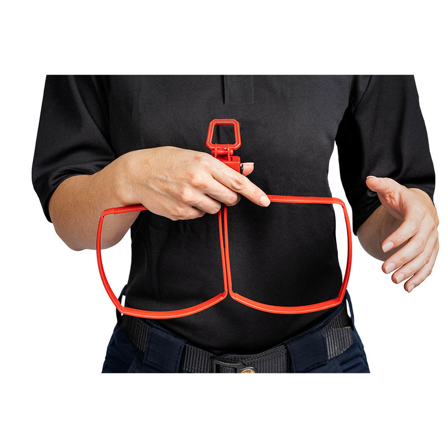 Person wearing a black shirt holding red training handcuffs on a white background