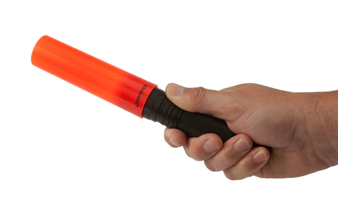 Hand holding a Nightstick Nesting Safety Cone flashlight, designed for directing traffic and illuminating hazards.