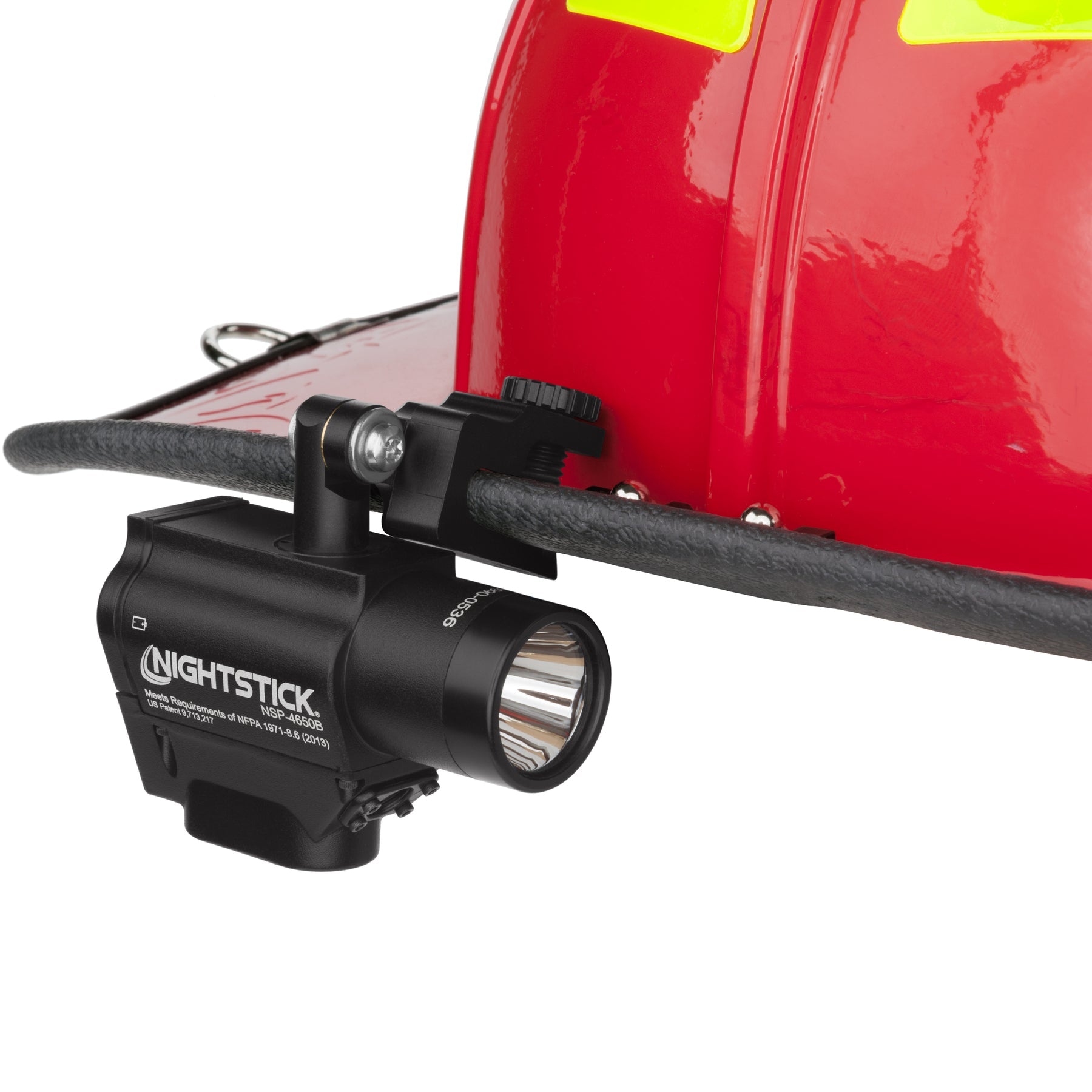Nightstick FORTEM dual-light flashlight mounted on the side of a fire helmet