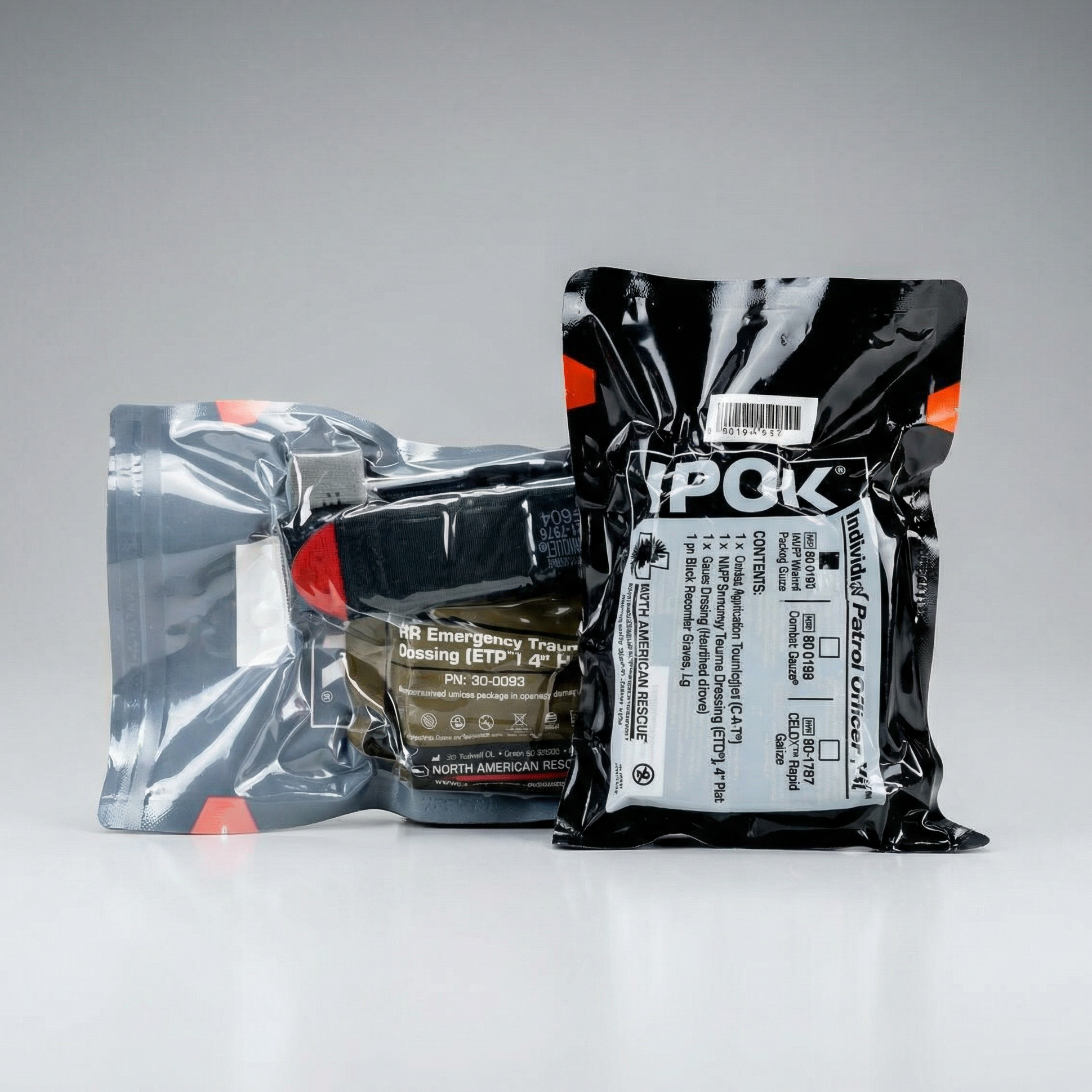 Three packages of North American Rescue (NAR) emergency supplies on a gray background