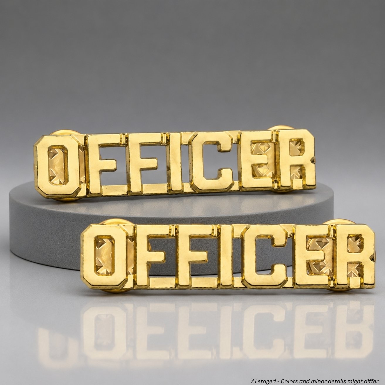 Close-up of First Class Uniforms gold-plated Officer Collar Pins pair IN54 showing cut-out block lettering and reflective faceted letter interiors