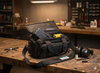 Black bag with tools on a wooden workbench in a workshop setting