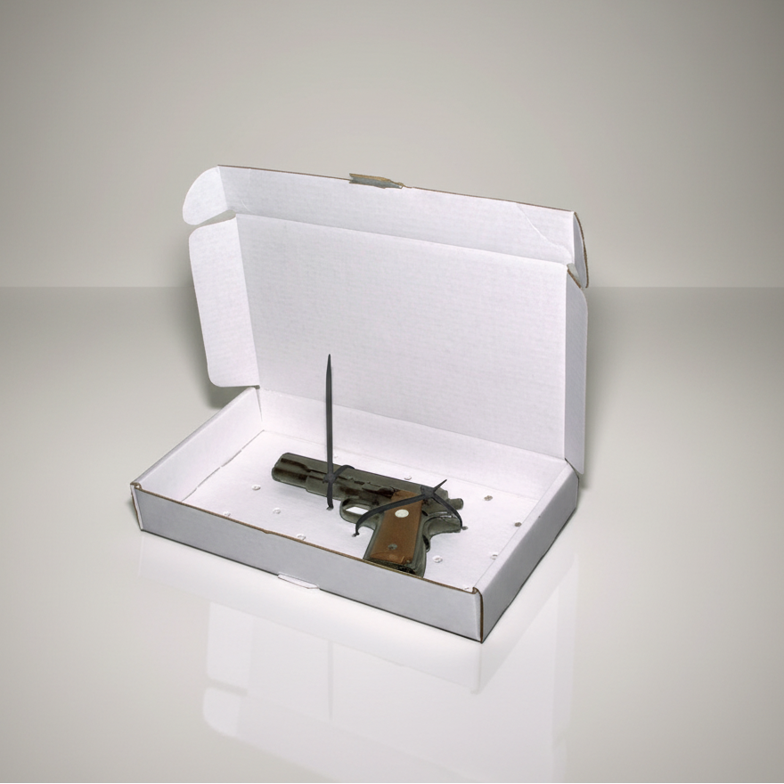 Small gun inside an open white evidence box on a gray background