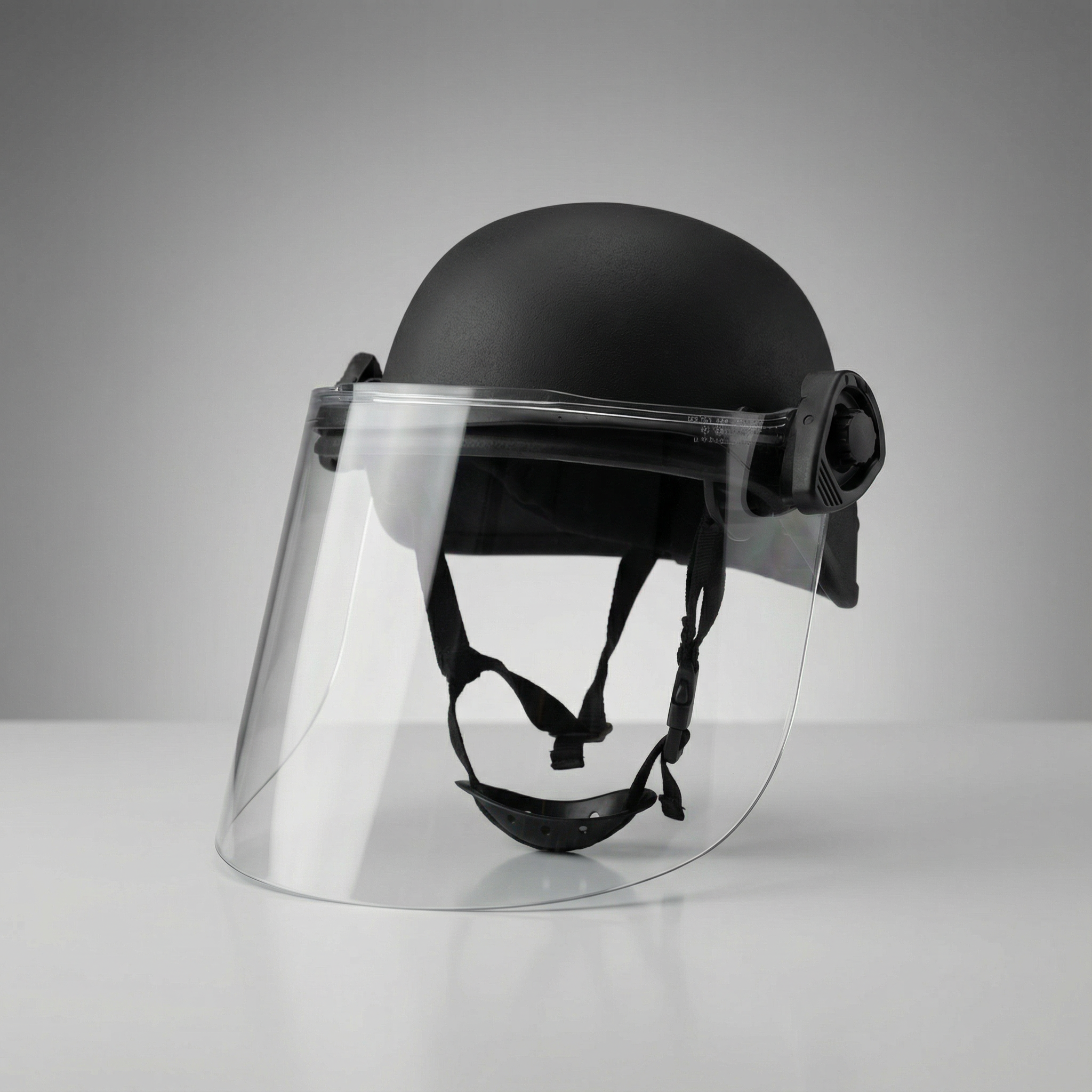 Black helmet with clear visor on a gray background