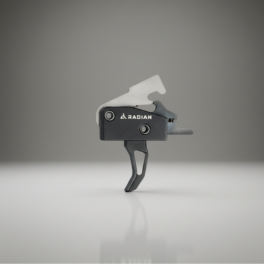 Black and gray firearm trigger on a reflective surface with a gradient gray background