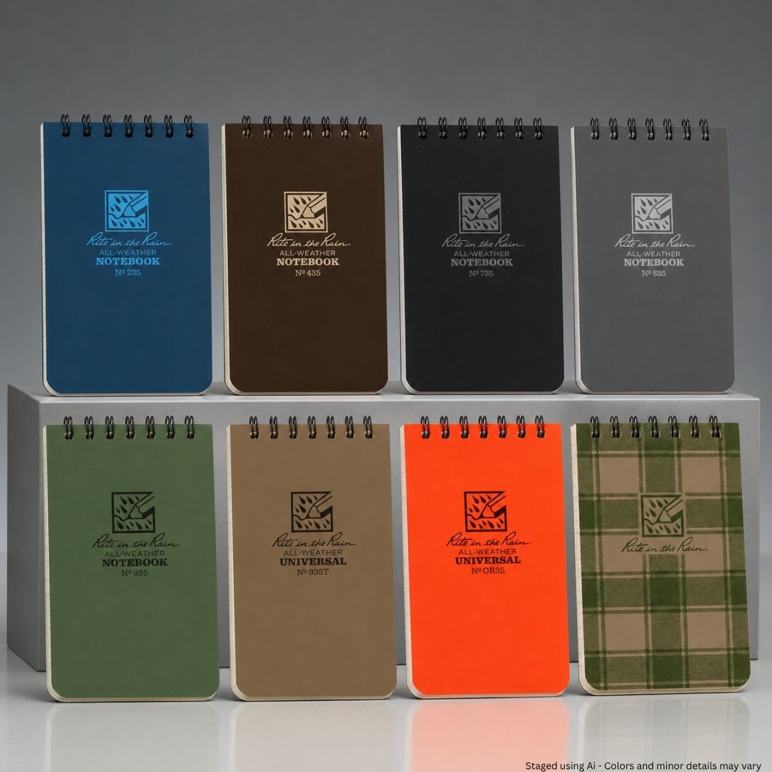 Set of notebooks in various colors with visible brand logo on a gray background