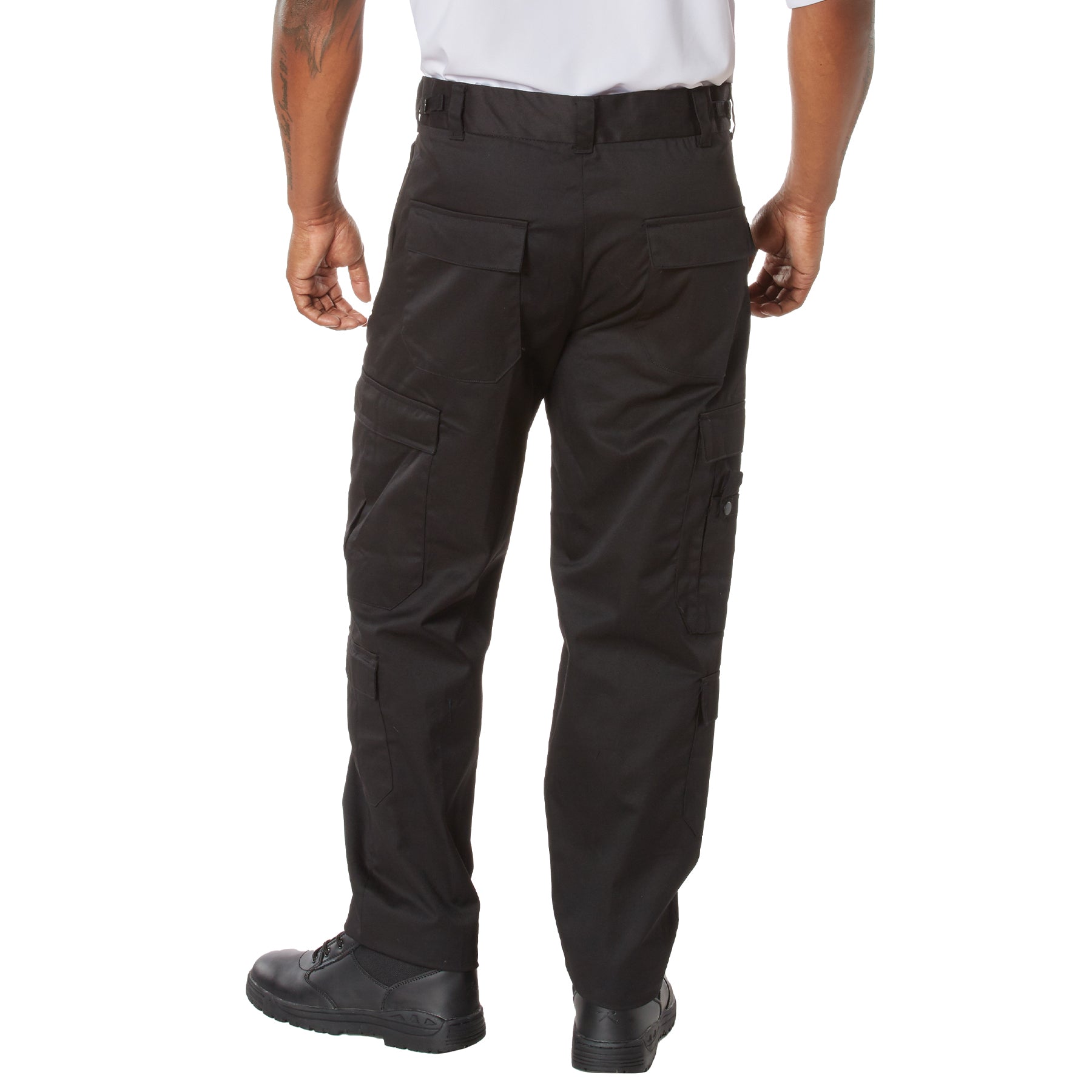 Black tactical pants worn by a person on a white background