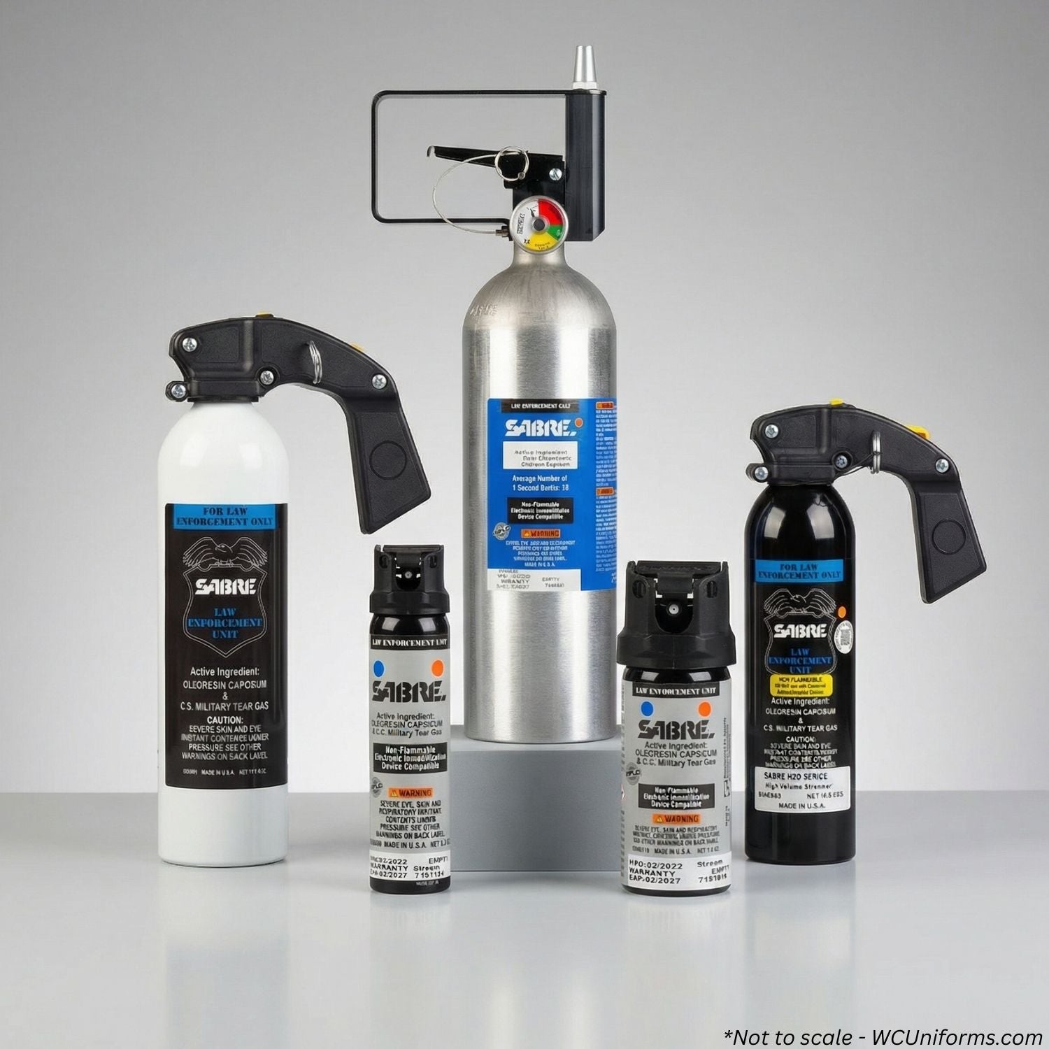 Collection of Sabre pepper spray products on a gray background