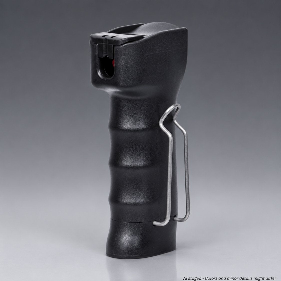 Black pepper spray device with a silver clip on a gray background