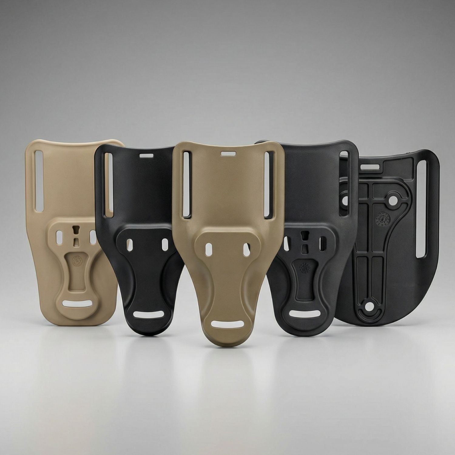 Two pairs of tactical holster loops in beige and black on a gray background