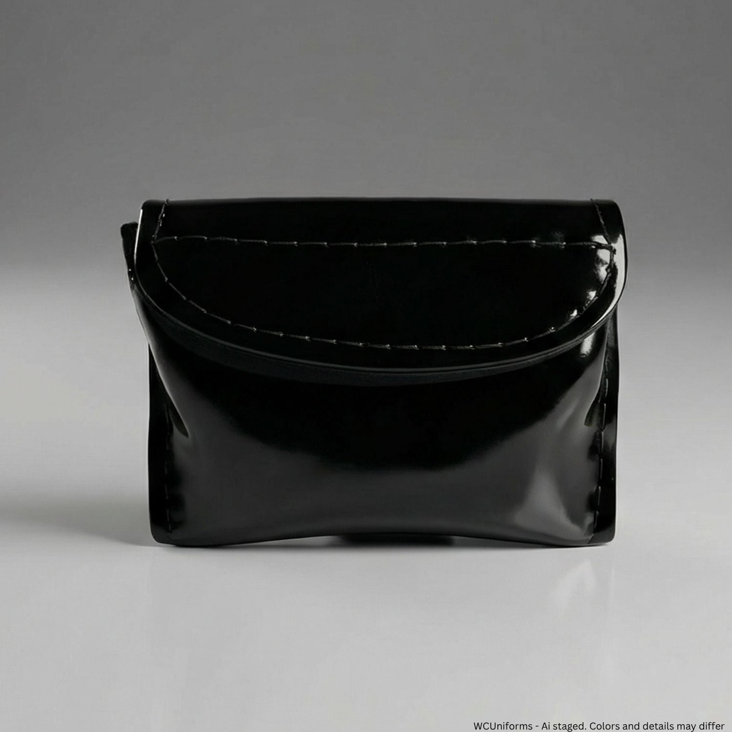 Black patent leather handbag on a gray background