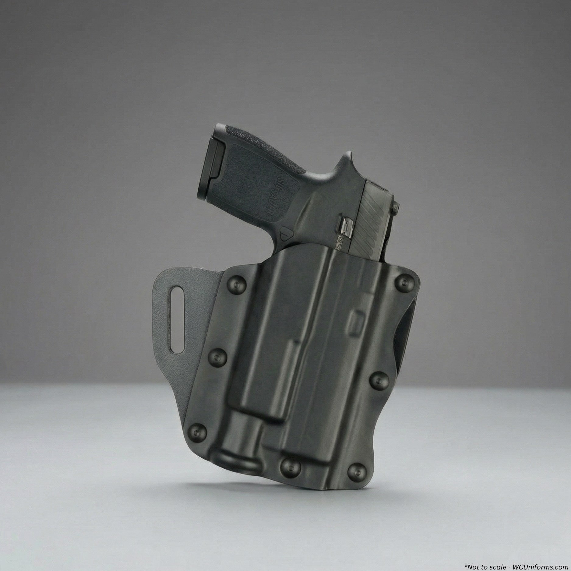 Black gun holster with a gun on a gray background