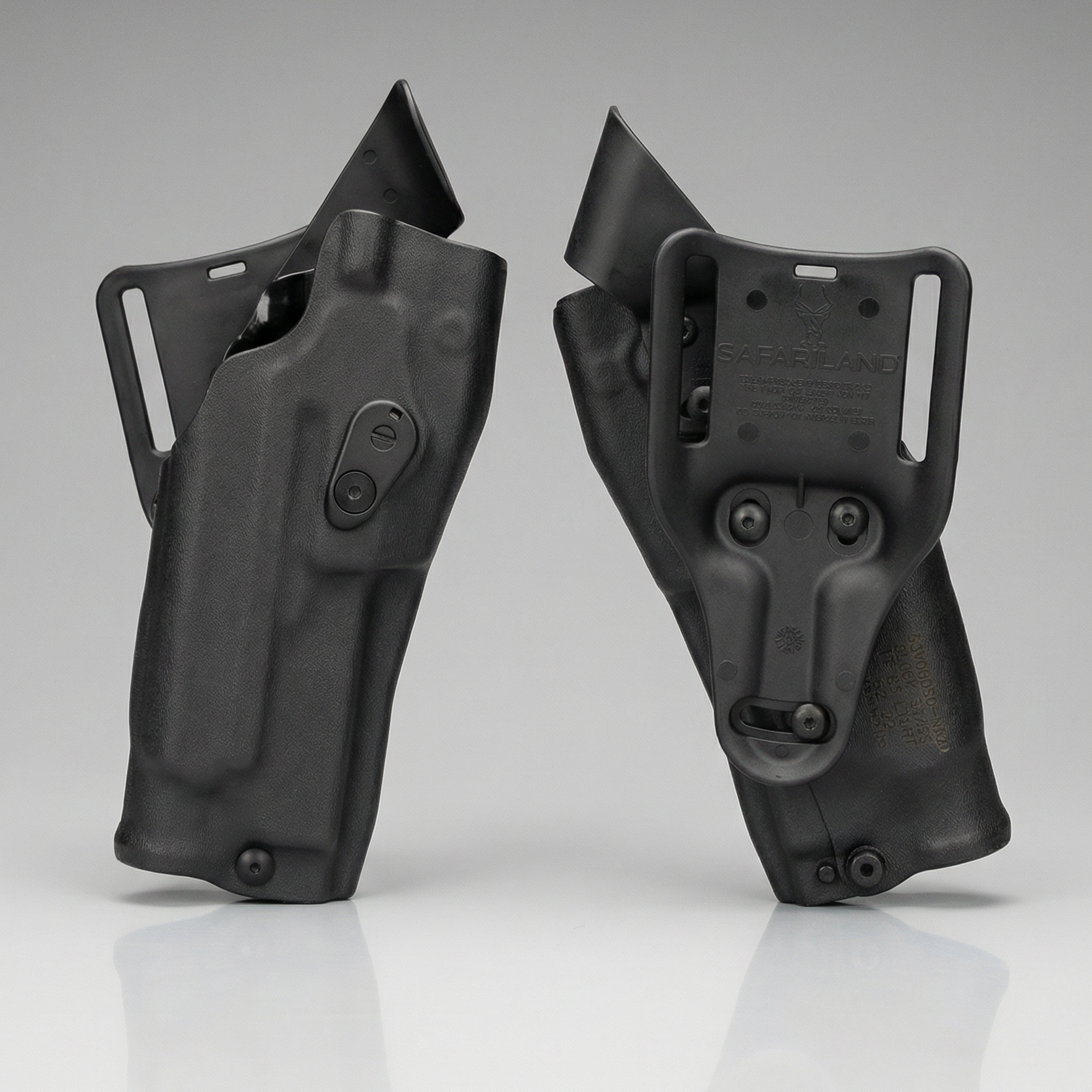 Two black gun holsters on a gray background